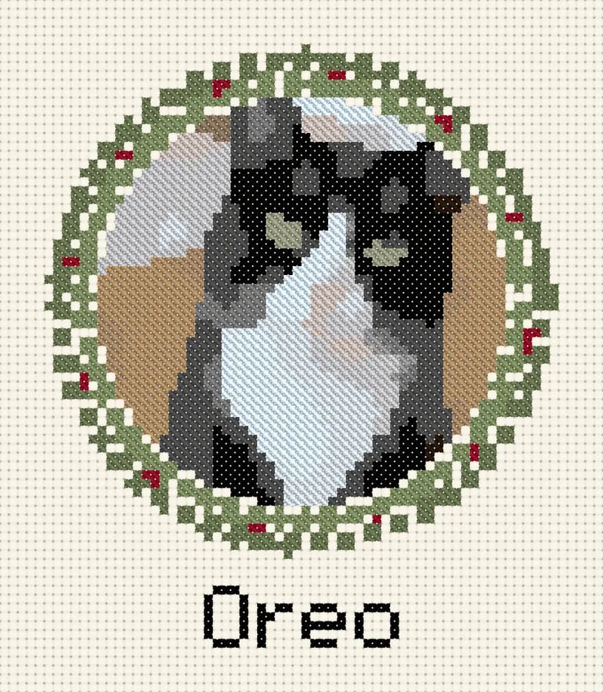 Tuxedo cat ornament: A small round ornament: 46 stitches across the portrait, a wreath and a name.